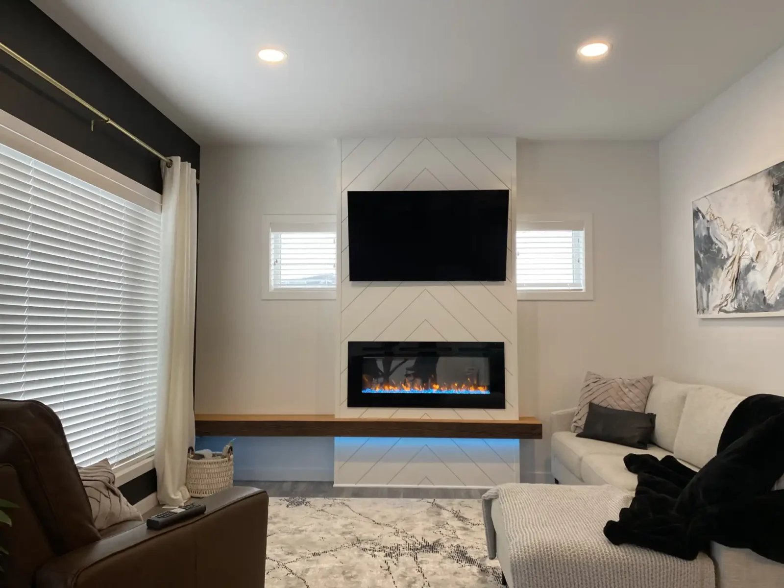 axium-interiors-saskatoon-fireplace-accent-lightingIMG_3570 Walkout basement with dark cabinetry and gold accents, bright and spacious with floor to ceiling windows